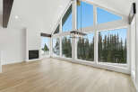 This stunning property boasts a bright and airy living space, highlighted by expansive windows that offer breathtaking views of the surrounding natural landscape.