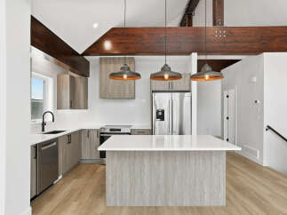 This stunning kitchen boasts a modern design with sleek cabinetry and a spacious island, perfect for both cooking and entertaining.