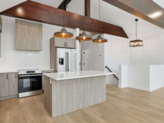 This stunning kitchen boasts modern design with sleek cabinetry and a spacious island, perfect for culinary enthusiasts.