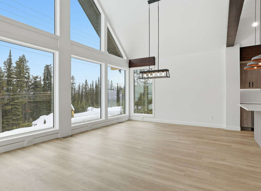 This stunning property boasts an open-concept living space with expansive windows that frame breathtaking views of the surrounding natural landscape.