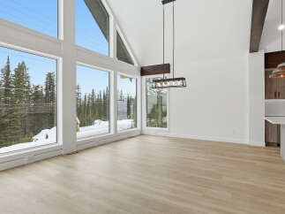 This stunning property boasts an open-concept living space with expansive windows that frame breathtaking views of the surrounding natural landscape.