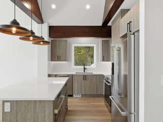 This stunning kitchen boasts modern design elements, including sleek cabinetry and a spacious island.