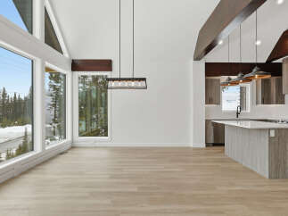 This stunning property boasts a modern open-concept design with high ceilings and expansive windows that flood the space with natural light.