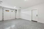 This spacious garage features a clean and modern design, perfect for storing vehicles and other belongings.