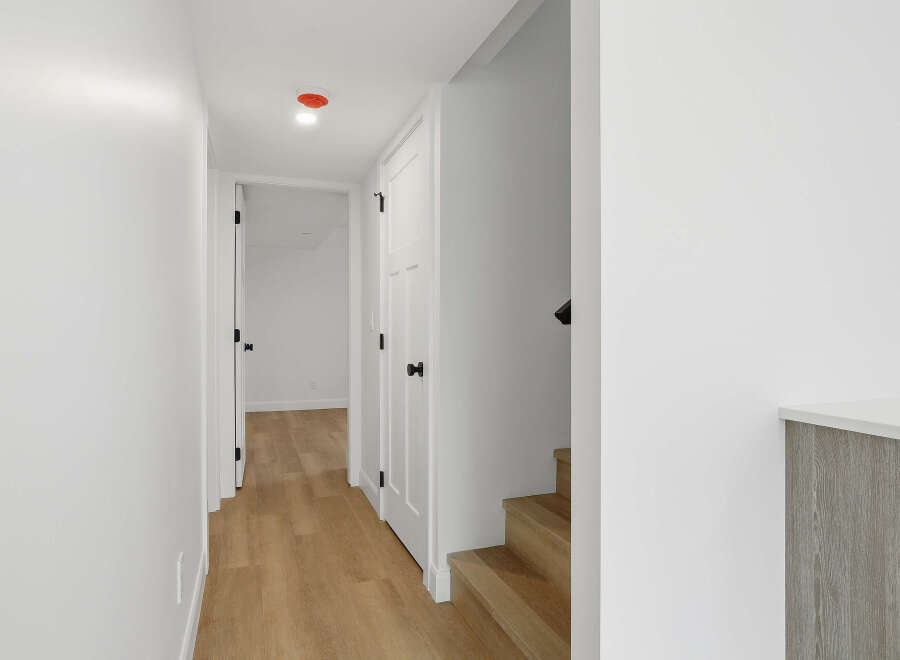This stunning property features a bright and airy hallway with beautiful hardwood floors.