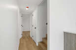 This stunning property features a bright and airy hallway with beautiful hardwood floors.