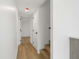 This stunning property features a bright and airy hallway with beautiful hardwood floors.
