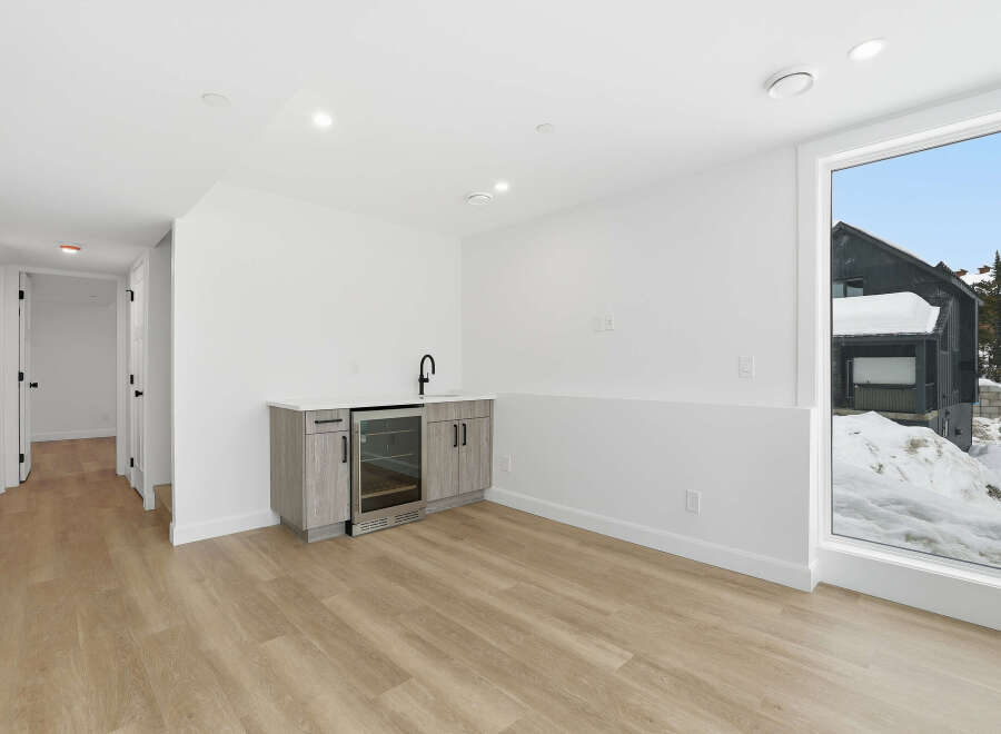 This stunning property boasts a modern interior with a sleek wet bar, perfect for entertaining guests.