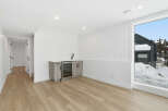 This stunning property boasts a modern interior with a sleek wet bar, perfect for entertaining guests.