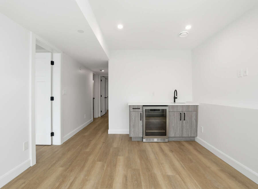 This modern space features a stylish wet bar, perfect for entertaining.