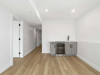 This modern space features a stylish wet bar, perfect for entertaining.