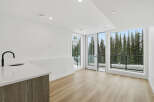 Experience modern living with this stunning property featuring a sleek kitchen design and expansive windows.