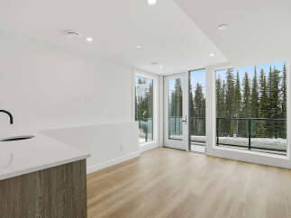 Experience modern living with this stunning property featuring a sleek kitchen design and expansive windows.