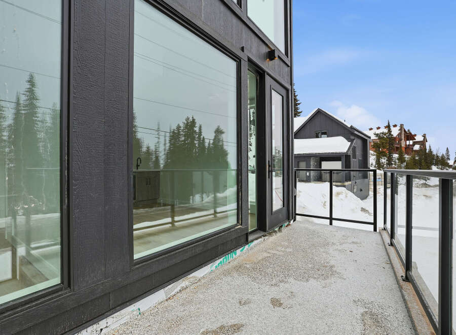 Experience luxury living with this stunning property featuring expansive windows and a private balcony.