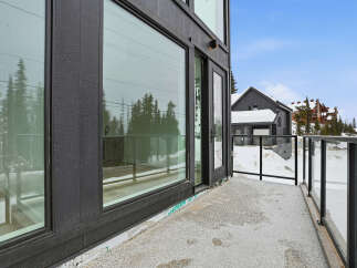 Experience luxury living with this stunning property featuring expansive windows and a private balcony.