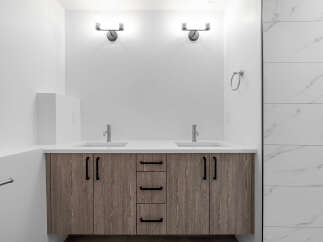 This modern bathroom boasts a sleek design with a double vanity and ample storage.