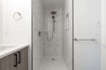 Step into a luxurious bathroom featuring a modern walk-in shower with elegant marble-like tiles.