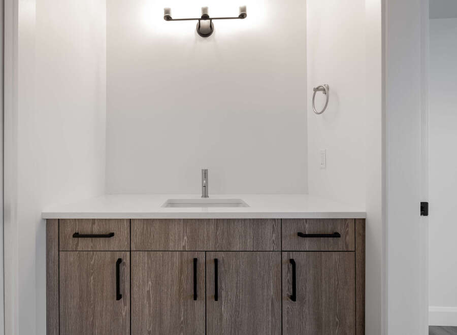 This stunning bathroom features a modern vanity with ample storage and a sleek countertop.