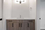 This stunning bathroom features a modern vanity with ample storage and a sleek countertop.