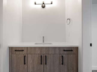 This stunning bathroom features a modern vanity with ample storage and a sleek countertop.