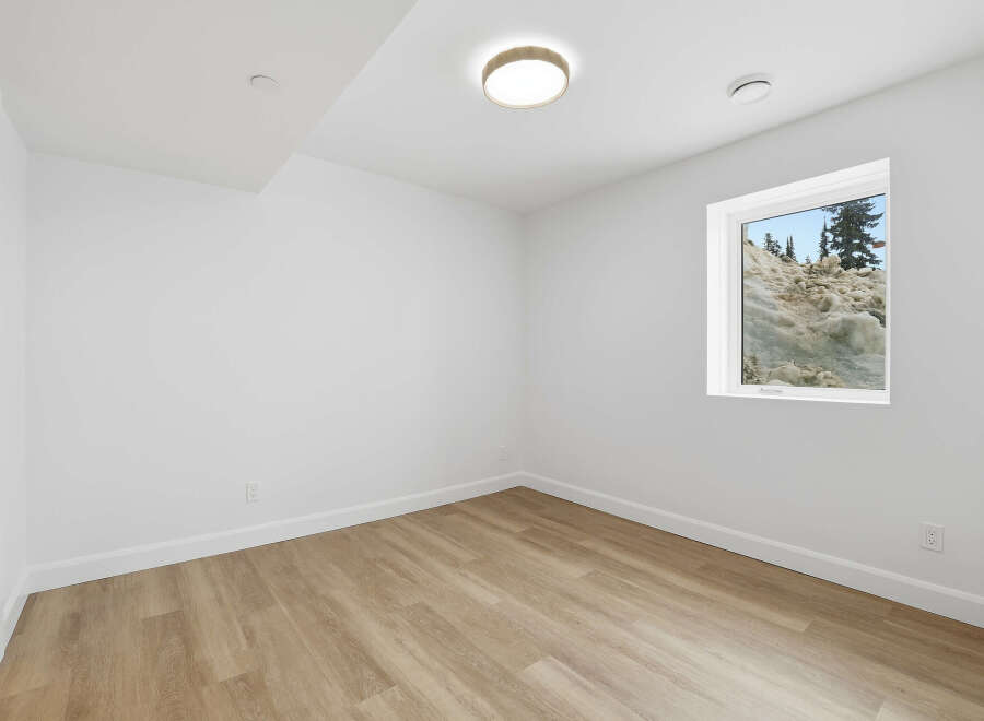 This bright and airy room features a neutral color palette, creating a versatile space for any design style.