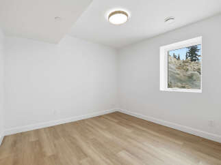 This bright and airy room features a neutral color palette, creating a versatile space for any design style.