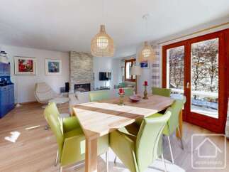 Experience luxury living in this stunning property, featuring a spacious dining area with a modern design.