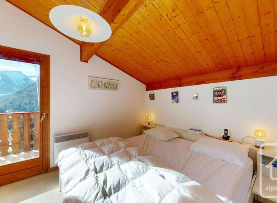 Experience the charm of this cozy bedroom with stunning mountain views.