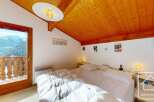 Experience the charm of this cozy bedroom with stunning mountain views.