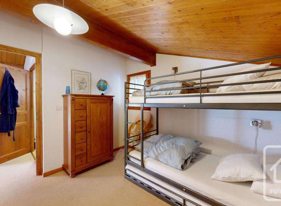 Discover this charming property featuring a cozy bunk bed, perfect for accommodating guests or family.