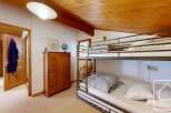 Discover this charming property featuring a cozy bunk bed, perfect for accommodating guests or family.