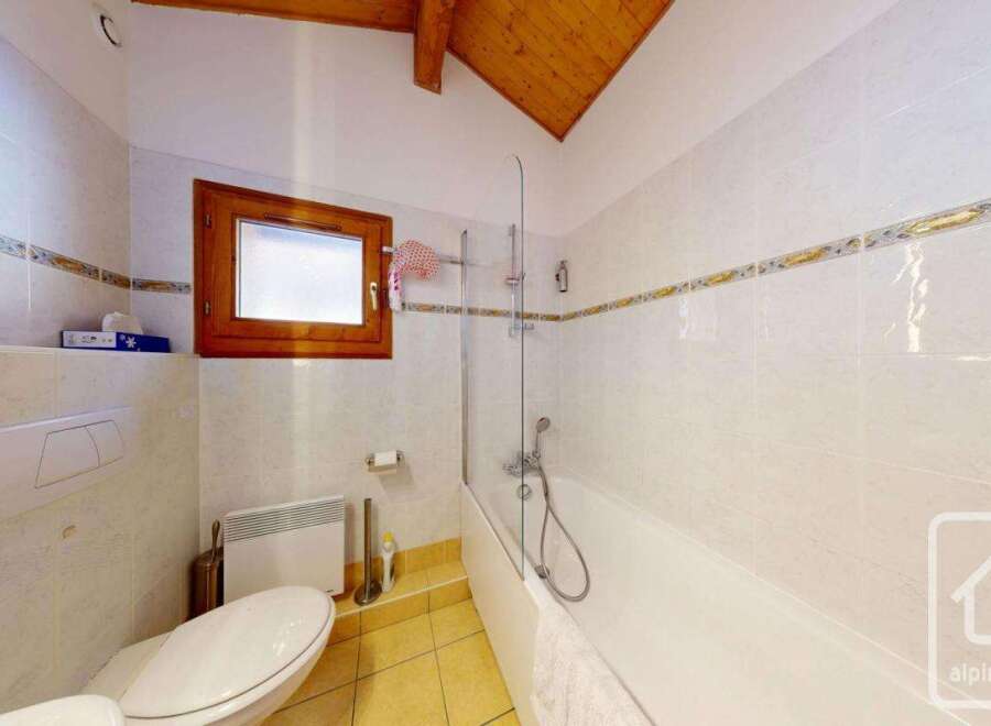 This charming bathroom features a bright and airy design, perfect for relaxation.
