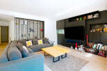 This stunning living room boasts a modern design with a cozy sectional sofa, perfect for relaxing and entertaining.