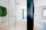 Step into luxury with this stunning bathroom featuring a sleek glass shower enclosure and elegant marble accents.