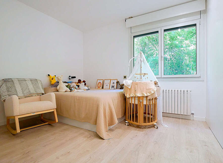 This charming nursery features a cozy rocking chair, perfect for soothing moments.