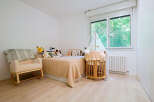 This charming nursery features a cozy rocking chair, perfect for soothing moments.
