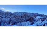 Nestled in a serene winter wonderland, this property offers breathtaking views of snow-covered trees and rolling hills.