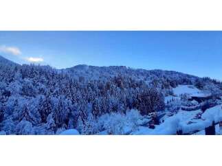 Nestled in a serene winter wonderland, this property offers breathtaking views of snow-covered trees and rolling hills.
