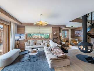 Experience the epitome of luxury living in this stunning property, featuring a cozy living room with a fireplace and a modern spiral staircase.