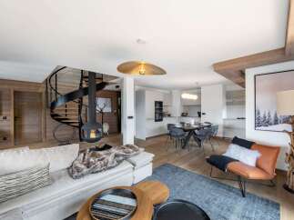 Experience luxury living in this stunning property, featuring a modern design with a cozy fireplace and a spiral staircase.