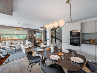 Experience luxury living in this stunning property, featuring a modern kitchen with sleek appliances and a spacious dining area perfect for entertaining.