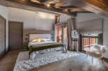 Experience luxury living in this stunning bedroom, featuring a cozy bed with a plush rug.