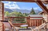 Enjoy breathtaking mountain views from this charming balcony.