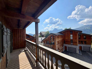 Experience the charm of alpine living with this stunning wooden chalet, offering breathtaking mountain views from its private balcony.
