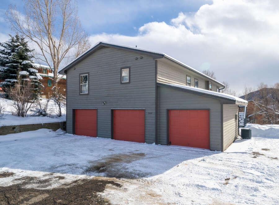 This stunning property boasts a modern design with a spacious three-car garage, perfect for storing vehicles or outdoor gear.