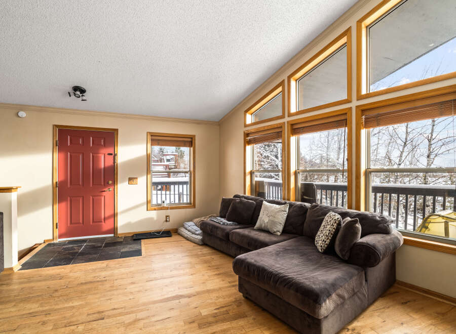 This stunning property boasts a spacious living area with a cozy sectional sofa, perfect for relaxing.