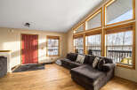This stunning property boasts a spacious living area with a cozy sectional sofa, perfect for relaxing.