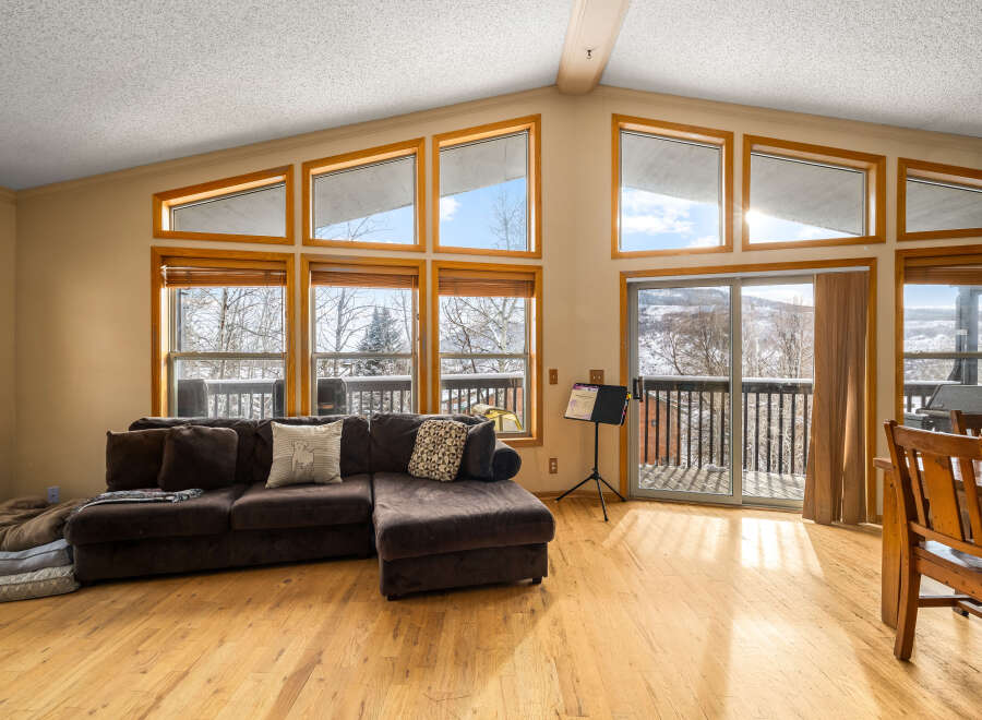This stunning property boasts a spacious living area with large windows that offer breathtaking views.