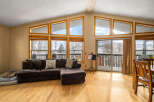 This stunning property boasts a spacious living area with large windows that offer breathtaking views.