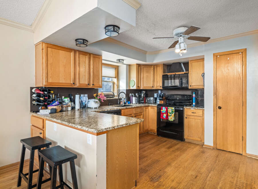 This stunning kitchen boasts beautiful wooden cabinetry and a spacious layout, perfect for both cooking and entertaining.